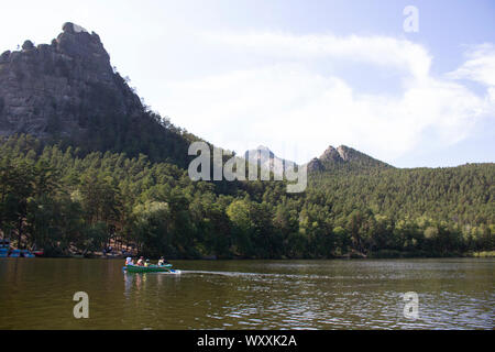 Cliff Okzhetpes and road autumn evening in Natonal park Burabay Stock Photo