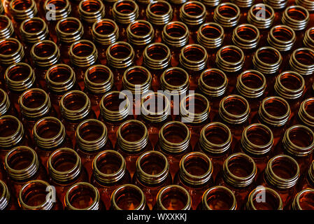 Many glass jars for empty medicines assorted in a row, chemical pharmaceutical industry concept. Stock Photo