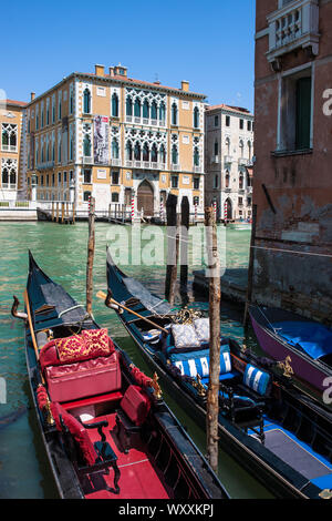 Palazzo Cavelli-Franchetti fronting the Grand Canal, Venice, Italy: opulent gondolas wait for passengers in the foreground Stock Photo