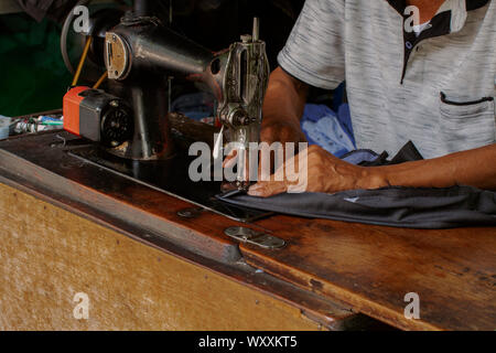 A traditional tailor in action at work Stock Photo