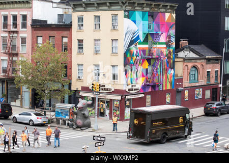 Street corner scene with UPS courier delivery truck, traffic lights, mural and Chelsea Square Market store at West 18th Street and Tenth Avenue in New Stock Photo