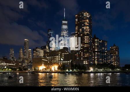 New York skyline at night showing the famous Freedom Tower (in place of the World Trade Centre) and the Hudson River from Pier 25 Stock Photo