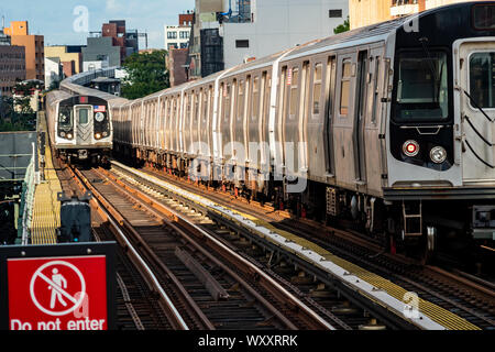 An “N” train approaches the Broadway station in Astoria in New York, passing a queue of trains on lay-up, on Sunday, September 1, 2019. (© Richard B. Levine) Stock Photo