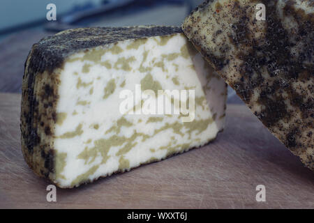 Craft cheese from cows and goats milk. Cheese head. Selective focus Stock Photo