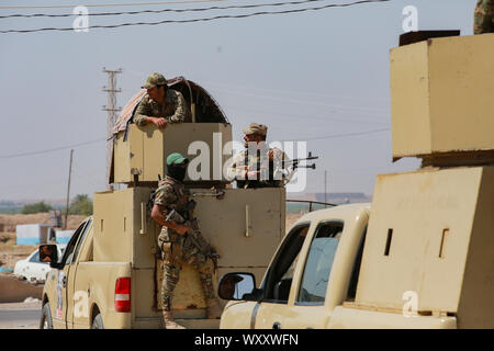 Samarra, Iraq. 18th Sep, 2019. Members of the Peace Companies (Saraya al-Salam), an Iraqi armed group linked to Iraq's Shia community and part of the Iraqi state-sponsored Popular Mobilization Forces (PMF), stands on fighting vehicle during security precautions against potential threats by the so-called Islamic State (IS) terror group. Credit: Ameer Al Mohammedaw/dpa/Alamy Live News Stock Photo