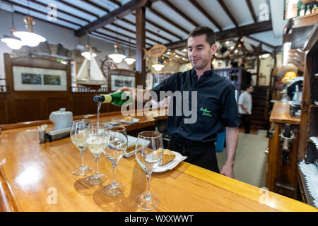 Pouring txakoli wine glass in Asador Iribar restaurant in Getaria, Gipuzkoa,  Basque Country, Spain Stock Photo