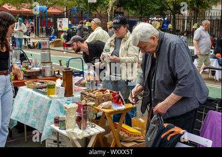 Shoppers search for bargains at the humongous 35th Annual Penn South Flea Market in the New York neighborhood of Chelsea on Saturday, September 14, 2019. The flea market appears like Brigadoon, only once every year, and the residents of the 20 building Penn South cooperatives have a closet cleaning extravaganza. Shoppers from around the city come to the flea market which attracts thousands passing through.  (© Richard B. Levine) Stock Photo