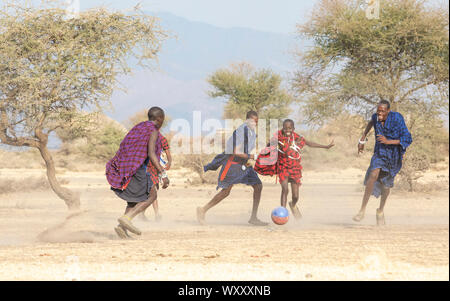 Arusha, Tanzania, 7th September 2019: maasai men playing football Stock Photo