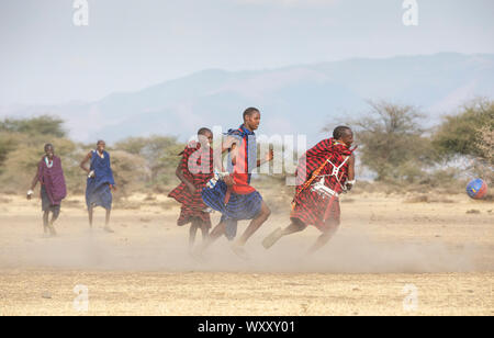 Arusha, Tanzania, 7th September 2019: maasai men playing football Stock Photo