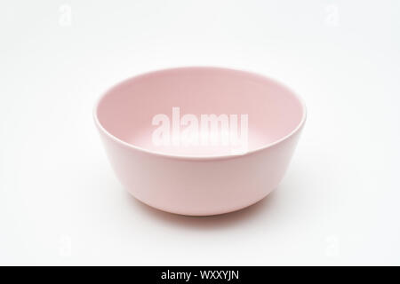 A pink bowl of crock isolated on white table and background Stock Photo