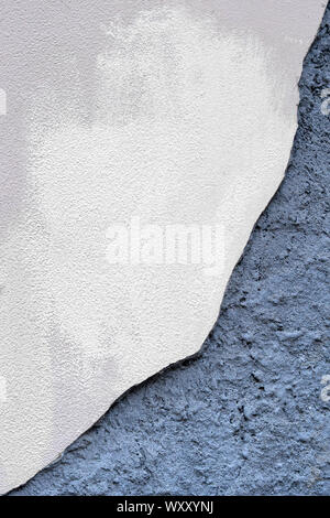 Concrete wall with partially damaged plaster. Stock Photo