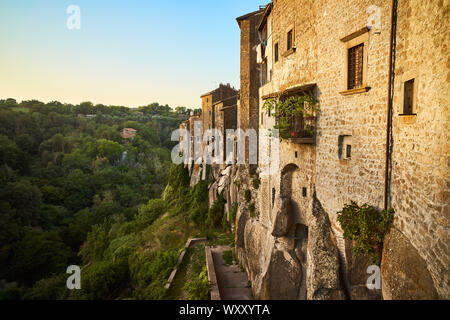 Landscape and panorama at sunset of the ancient medieval village of Vitorchiano in the province of Viterbo, with woods and old houses with stone brick Stock Photo