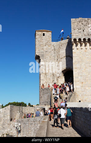 Dubrovnik city walls travel; tourists climbing to Fort Minceta, the highest point on the city wall, Dubrovnik old town, Dubrovnik Croatia Europe Stock Photo