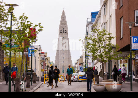 REYKJAVIK, ICELAND - Hallgrimskirkja, white concrete church and tourists. Stock Photo