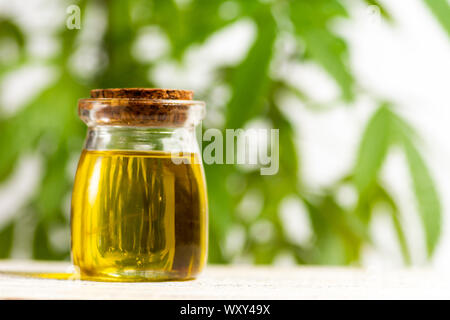 Cannabis oil and marijuana leafs close up Stock Photo