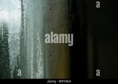 Droplets or drops of water on misted glass. Stock Photo