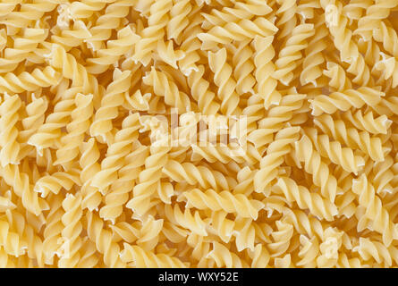 Uncooked fusilli pasta background Stock Photo