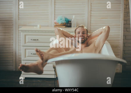 Man having joyful morning in bathtub Stock Photo