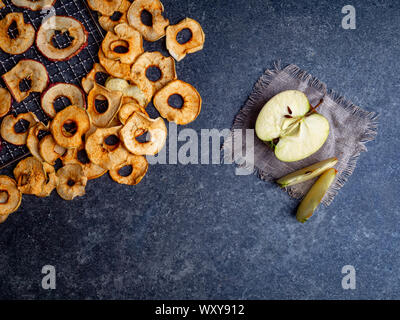 fresh applewith pieces of dry in dehydrator slices of yellow and red apples, healthy snack concept Stock Photo