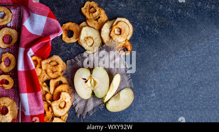 fresh applewith pieces of dry in dehydrator slices of yellow and red apples, healthy snack concept Stock Photo