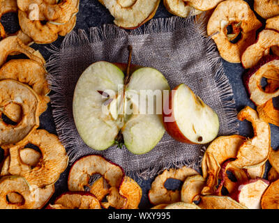 fresh applewith pieces of dry in dehydrator slices of yellow and red apples, healthy snack concept Stock Photo