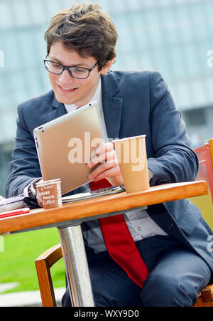 Young executive doing planning with business team outdoors at a table Stock Photo