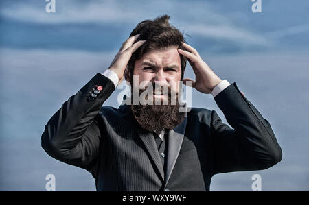 Stressful business. Pain and migraine. Frustration and disappointment. Unforgivable mistake. Business failure. Man bearded stressful painful face sky background. Guy suffer headache stressful day. Stock Photo