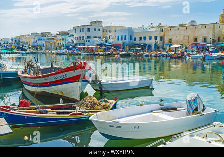 BIZERTE, TUNISIA - SEPTEMBER 4, 2015: Many old wooden fishing boats are moored in port, that is the center of old town, on September 4 in Bizerte Stock Photo