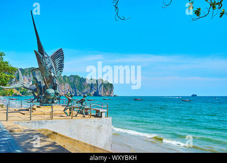 AO NANG, THAILAND - APRIL 25, 2019: The monument of giant marlin fish and fishermen, trying to catch it, is erected in the central seaside promenade, Stock Photo