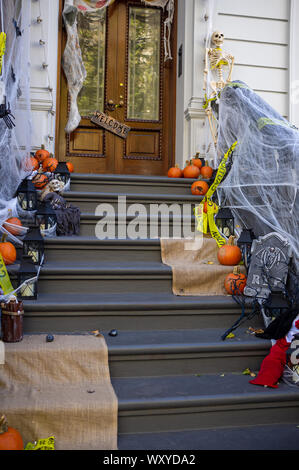 halloween decorations on entrance stairs of townhouse in New York City USA Stock Photo