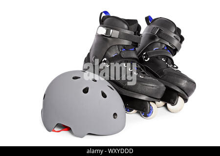 Close up of black aggressive inline skates and a helmet, isolated on white background. Stock Photo