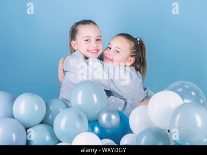 Girls best friends near air balloons. Birthday party. Happiness and cheerful moments. Carefree childhood. Start this party. Sisters organize home party. Having fun concept. Balloon theme party. Stock Photo