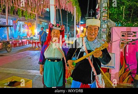 PAI, THAILAND - MAY 5, 2019: The senior Lisu Hill Tribe members make musical performance with tseubeu banjo-like musical instrument in Walking Street, Stock Photo