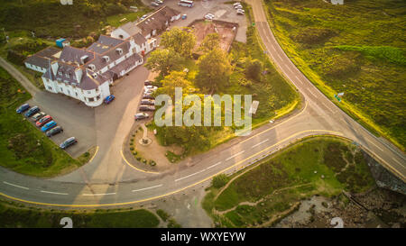 Sligachan Hotel and parked cars around, standing on the road in Glen Sligachan, Isle of Skye, aerial view Stock Photo