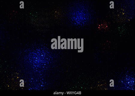White blue red yellow green multi-colored highlights on black abstract background Stock Photo