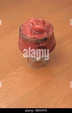 Strawberry smoothie, healthy cold drink served in glass on wooden desk with isolated background