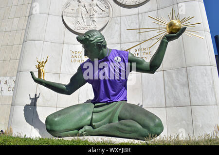 Spirit of Detroit statue sports giant purple sweater and bow tie to support  Detroit Youth Choir 