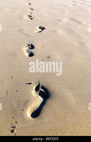 Footprints in the sand on a beach, Formentera, Spain Stock Photo