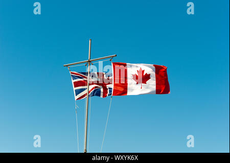 Canadian and British Flags flying together Stock Photo