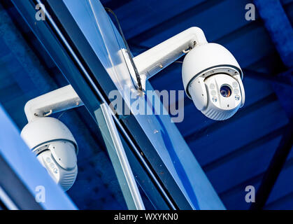 Close-up of modern CCTV camera on the wall of an industrial building Stock Photo