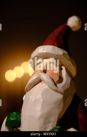 santa claus decoration in front of candle lights Stock Photo
