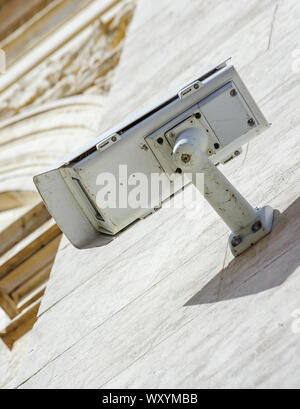 security CCTV camera or surveillance system fixed on old construction wall Stock Photo