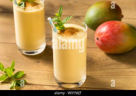 Homemade Sweet Indian Mango Lassi Smoothie with Mint Stock Photo