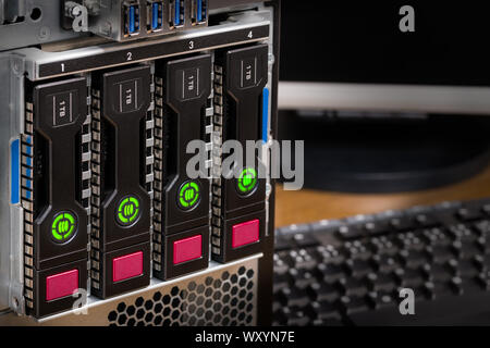 Hot-swap hard disk drives with data storage virtualization technology. Redundant array of independent disks in a server case detail. Secure backup. Stock Photo