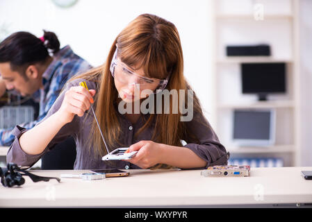 The two technicians working at computer warranty center Stock Photo