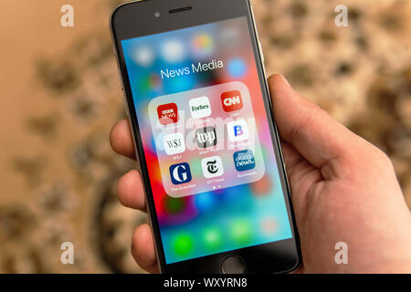 Black Apple iPhone with icons of News media: BBC News, Forbes, CNN, WSJ, WP, Bloomberg, Guardian, NY Times and Euronews applications on the screen Stock Photo