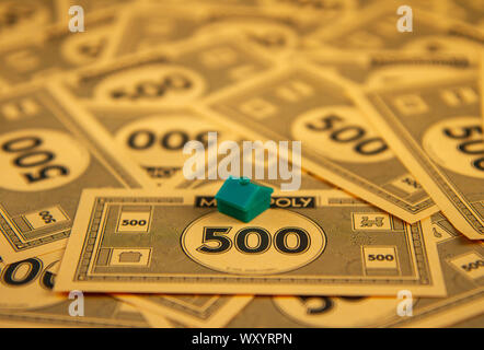 Debt from buying houses in the game of monopoly Stock Photo