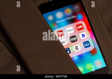 Black Apple iPhone with icons of News media: BBC News, Forbes, CNN, WSJ, WP, Bloomberg, Guardian, NY Times and Euronews applications on the screen Stock Photo