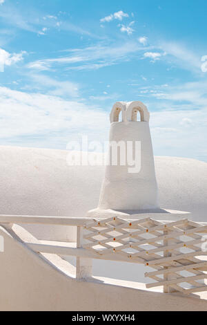 The whitewashed building and chimney in Oia, Santorini in the Greek Islands Stock Photo