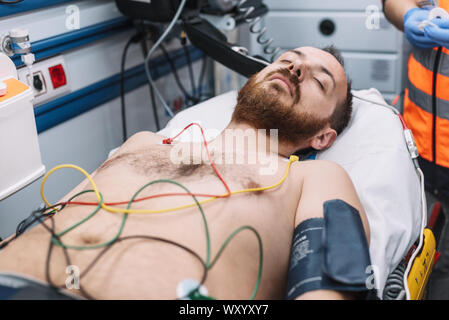 Paramedic attending to patient in ambulance . Stock Photo